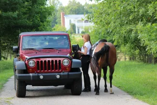 Photo by Jeremie: https://www.pexels.com/photo/woman-with-a-horse-talking-to-a-man-in-a-car-15645367/